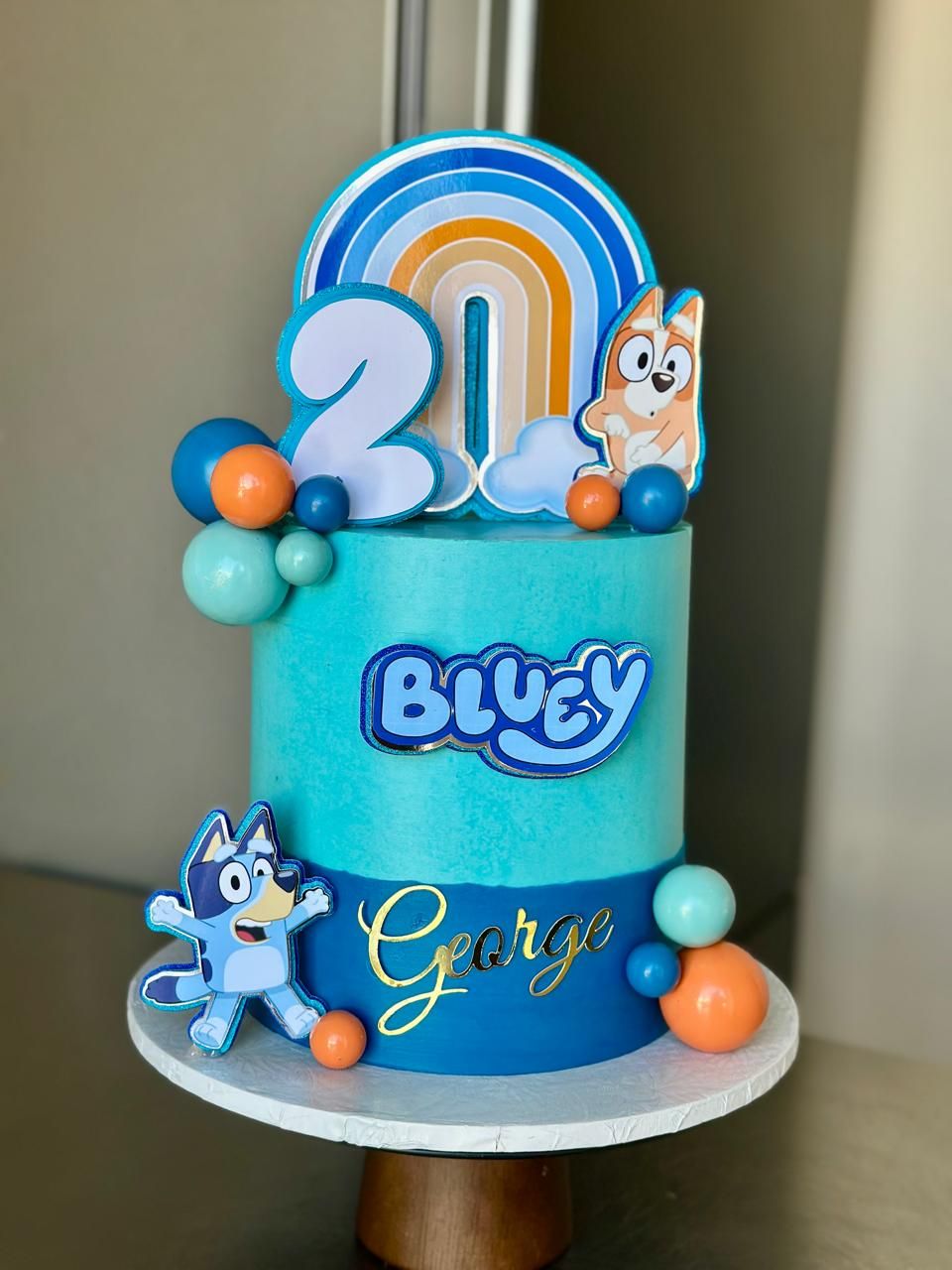 Bluey Ombré Rainbow — a custom cake by Sky Cakes